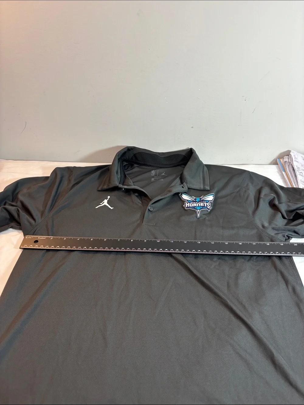 Jordan Black Charlotte Hornets Polo with White Jumpman. 0189
